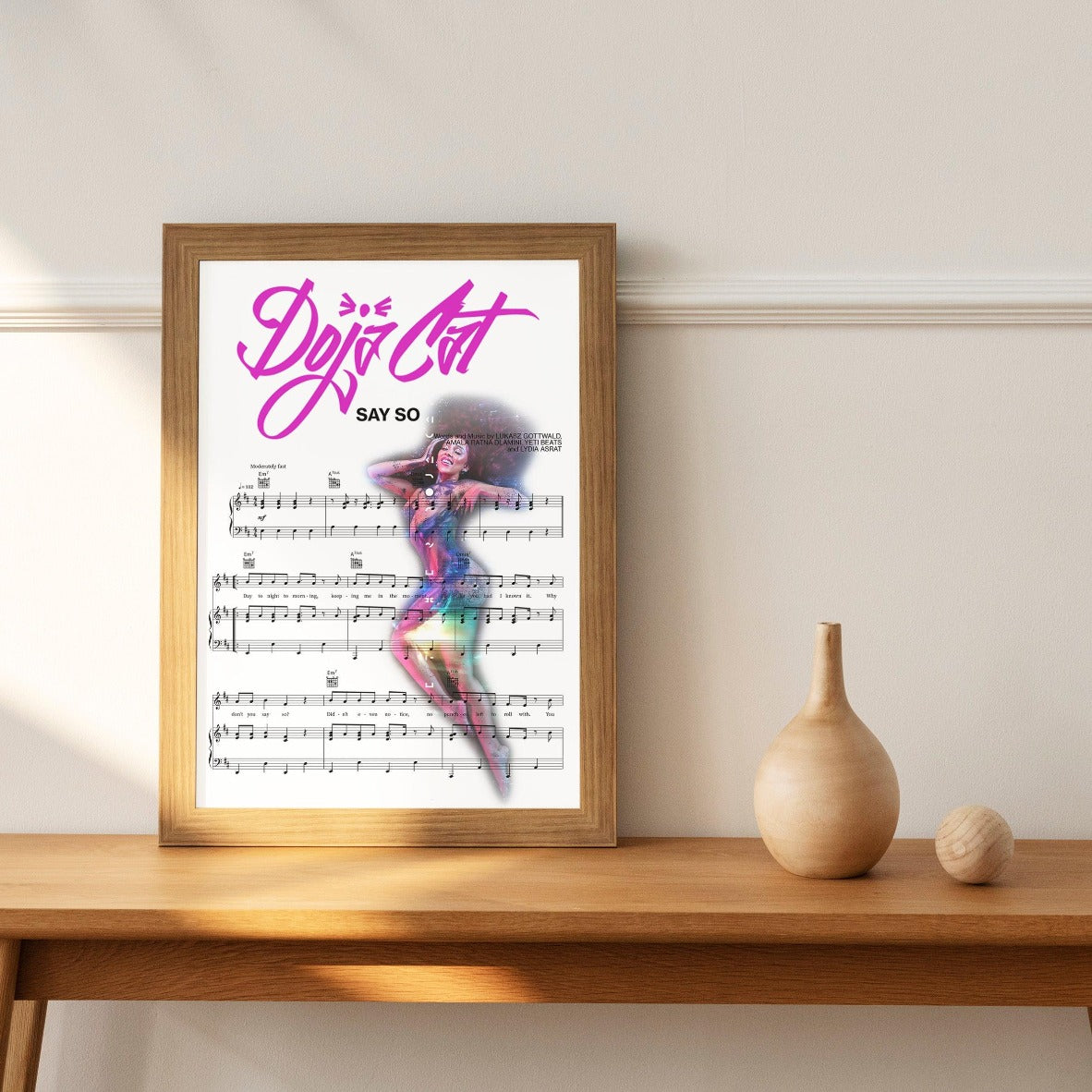 Add character and style to your home with this Doja Cat - Say So Poster. Perfect for any music-lover, this piece of art is brimming with vibrant colors and intricate details that instantly draw the eye. A wonderful way to express your love for music, this wall art does not disappoint in its high-quality print that is sure to stand out in any room of your home. Displaying a memorable quote from one of Doja Cat's songs, this poster makes a timeless addition for those who appreciate an elegant touch.