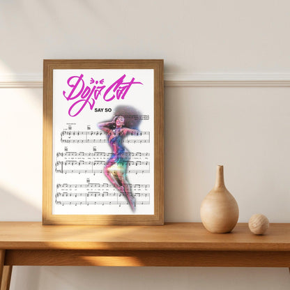 Add character and style to your home with this Doja Cat - Say So Poster. Perfect for any music-lover, this piece of art is brimming with vibrant colors and intricate details that instantly draw the eye. A wonderful way to express your love for music, this wall art does not disappoint in its high-quality print that is sure to stand out in any room of your home. Displaying a memorable quote from one of Doja Cat's songs, this poster makes a timeless addition for those who appreciate an elegant touch.