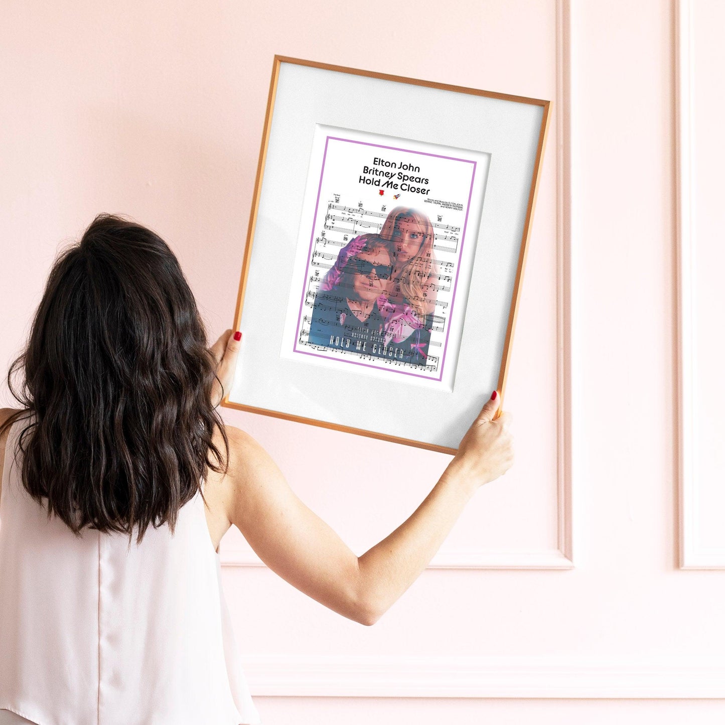 Looking for some amazing wall art to enhance your home? Check out the Elton John, Britney Spears - Hold Me Closer Poster from 98Types. This poster is perfect for adding some musical flair to your home. Plus, it's a great way to show your support for two of the most iconic pop stars of our generation.