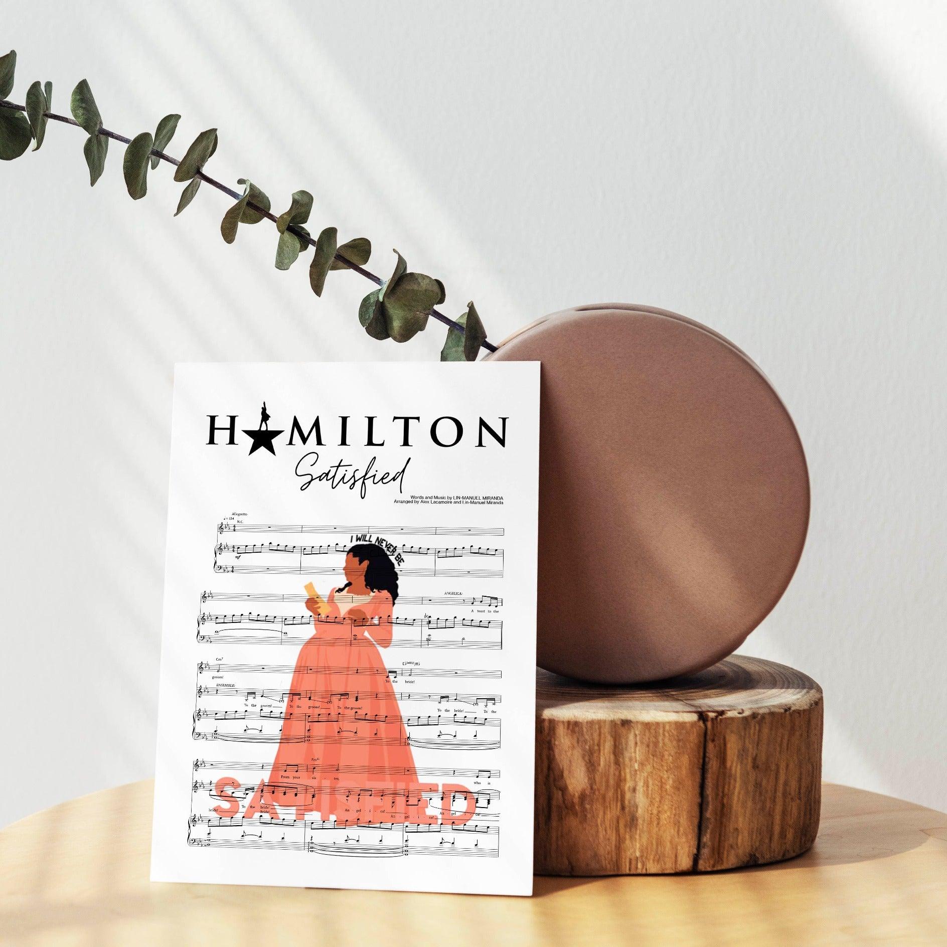 Accentuate your bedroom with the iconic Hamilton - SATISFIED Poster. Perfect for any original Hamilton fan, this poster celebrates the brilliance of the show with a sleek, modern style. Thanks to the high-quality printing, the vibrant colors will stay true so you can admire its beauty for years to come. With the contemporary poster, you'll be reminded of the impact Hamilton has had on not just theater but culture as a whole. 