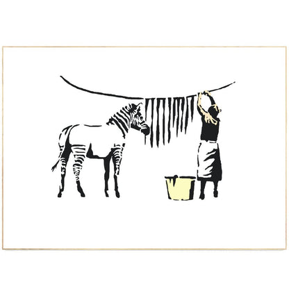 Add some edge to your walls with this Banksy art piece. Painted in 2006, this street art depiction of a washing zebra is a must-have for any Banksy fan. Measuring 12"x16", this print is the perfect size for any room. Hang it in your living room, bedroom or office for an instant pop of color and personality.