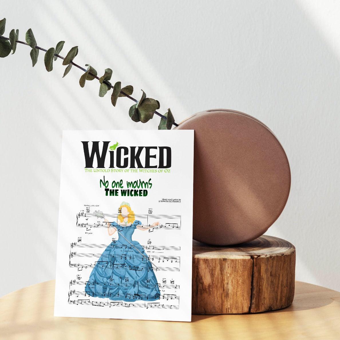 Hang this beautifully designed and hand-crafted poster in your home to show your love for the music of Wicked. This gorgeous poster features the song lyrics from Wicked - NO ONE MOURNS THE WICKED. Perfect for any fan of the musical Wicked, this poster is a must-have for your collection.